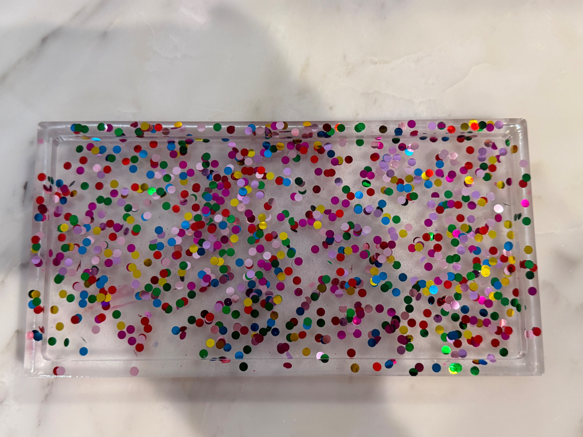 Clear resin trinket tray filled with multicolour confetti