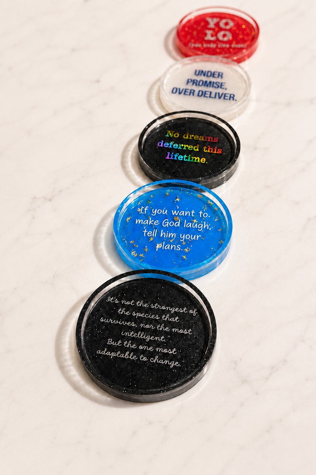 Collection of colorful resin coasters personalized with inspirational sayings