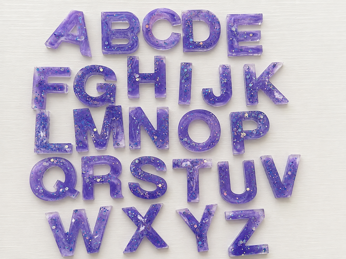 Full set of purple glitter resin alphabet letters A through Z